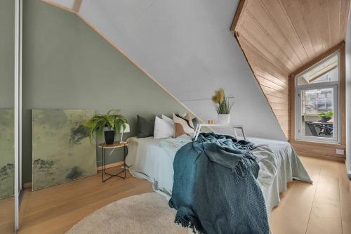 a bedroom with a bed and a large window at Apartment in Tromsø city center in Tromsø