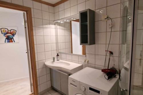 a bathroom with a sink and a mirror at Apartment in Tromsø city center in Tromsø