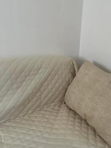 an unmade bed with a pillow on top of it at Tentazioni Rooms in Tramonti