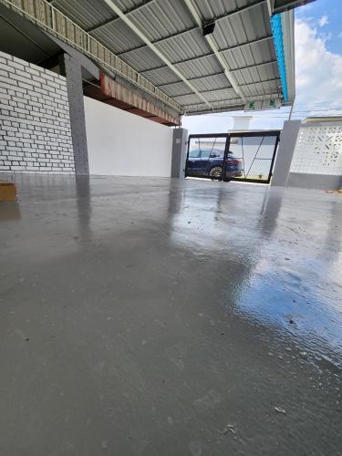 a large empty parking lot with a car in the background at Sun Shine Home by Ipoh Maju Stay in Ipoh
