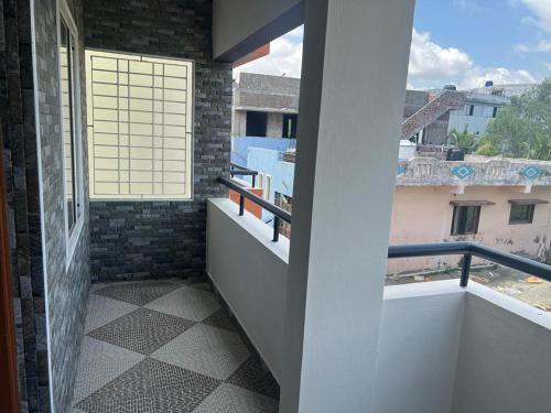 a balcony with a view of a building at Rt Service Apartments Hotel in Velankanni