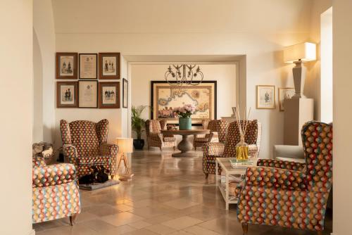 a living room filled with chairs and a table at Relais Palazzo del Barone in Sorrento