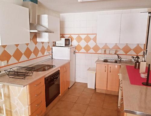a small kitchen with a sink and a stove at Apartamento Daniella Nerja in Nerja
