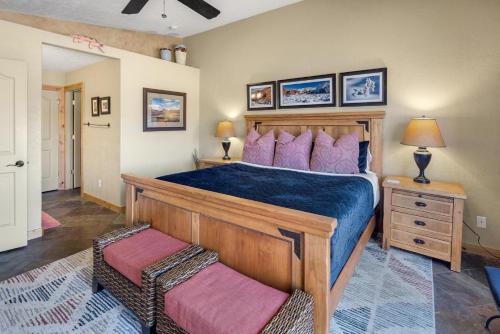 a bedroom with a large wooden bed with purple pillows at Rim Village I1 in Moab