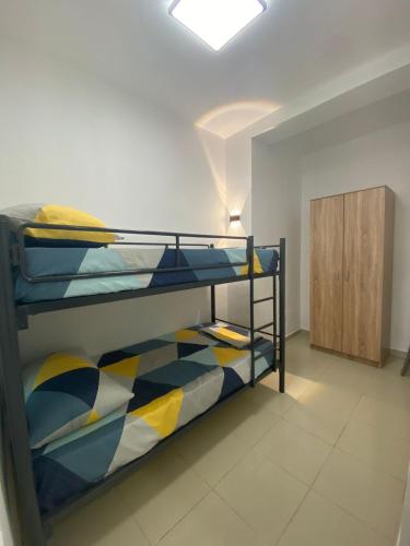a bedroom with two bunk beds and a cabinet at Sea Apartment Golem in Golem