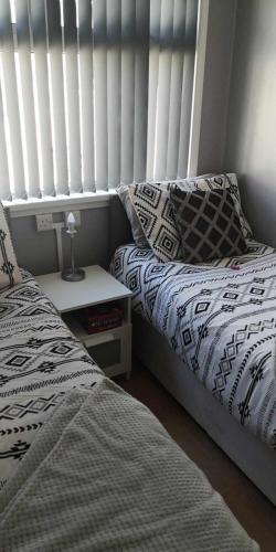 two beds sitting next to each other in a bedroom at 84A South Shore Village in Bridlington
