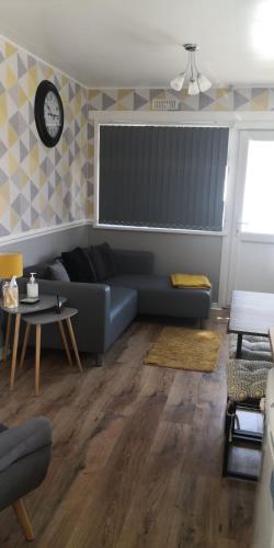a living room with a couch and a table at 84A South Shore Village in Bridlington