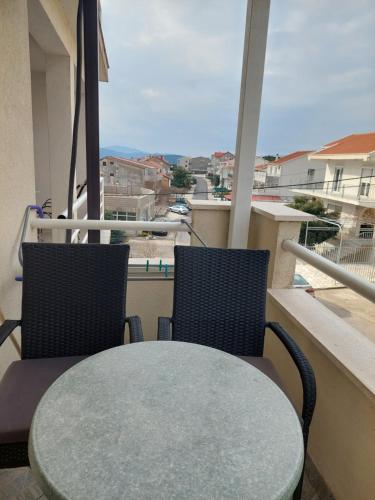 a table and two chairs on a balcony with a view at Royal Apartments in Neum