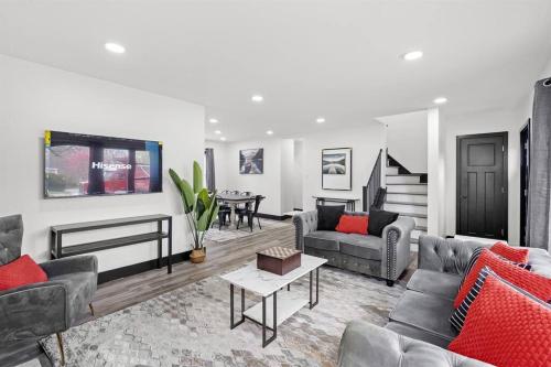a living room with couches and a table at Roomy Retreat-Family & Friends 2 King Bed Game Room in Chesterton