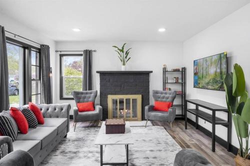 a living room with a couch and a fireplace at Roomy Retreat-Family & Friends 2 King Bed Game Room in Chesterton