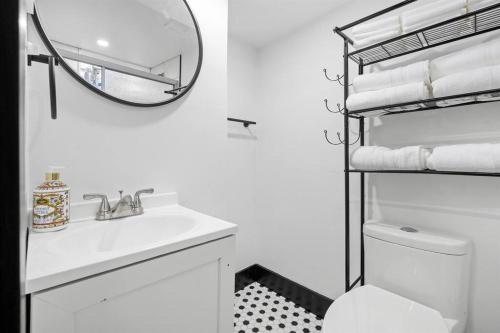 a white bathroom with a sink and a mirror at Roomy Retreat-Family & Friends 2 King Bed Game Room in Chesterton