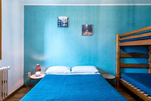 a blue bedroom with a bed with a blue wall at Le Charmagit in La Roche-sur-Foron