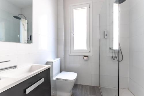 La salle de bains est pourvue de toilettes, d'un lavabo et d'une douche. dans l'établissement Apartamento Zubia Barakaldo BEC Bilbao, à Barakaldo