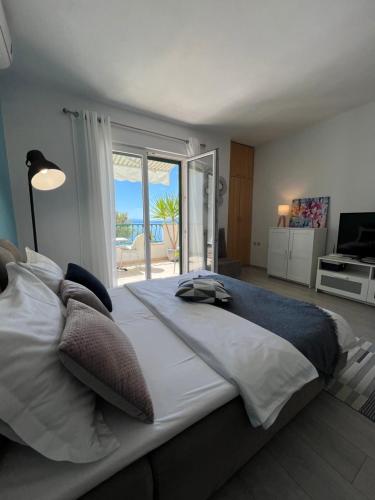 a bedroom with a large bed with a view of the ocean at Apartment Chiara in Tučepi