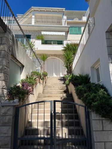 a stairway leading up to a building with a gate at Apartment Chiara in Tučepi