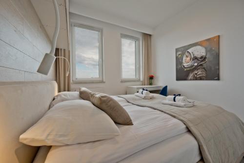 Łóżko lub łóżka w pokoju w obiekcie BlueApart Apartamenty Nexo