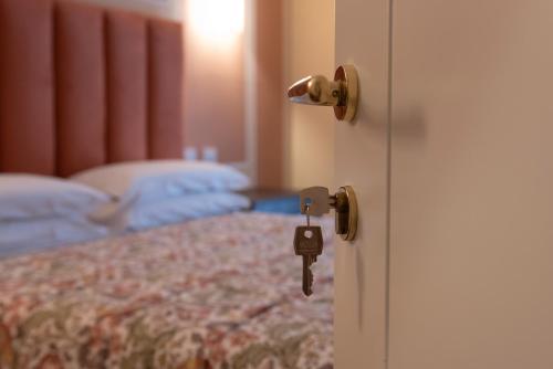 a door with a key in a bedroom at I Castagni in Vigevano