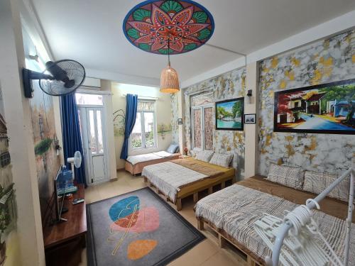 a small room with two beds and a room with at H2 homestay phố cổ check in tự động in Hanoi
