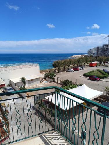 a view of the ocean from a balcony at Sea side apartment with balcony and private park in Monopoli