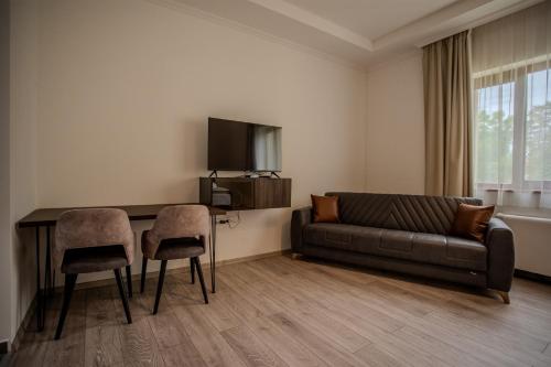 a living room with a couch and a table at Hotel Golden Palace in Göd