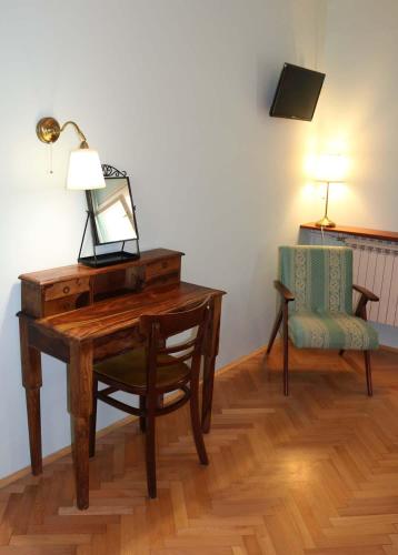a desk with a mirror and a chair in a room at Villa Katarina Lošinj Island in Mali Lošinj