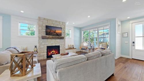 a living room with a couch and a fireplace at Lux Beach Home Lake Views Firepit in South Haven