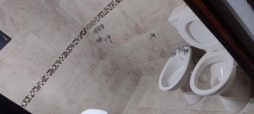 a bathroom with a toilet and a sink at LA CASA in Villa Anizacate