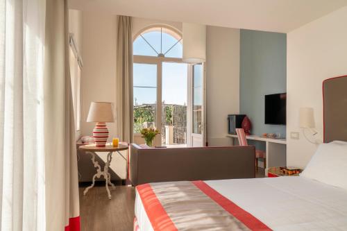 Ένα ή περισσότερα κρεβάτια σε δωμάτιο στο Relais Palazzo del Barone