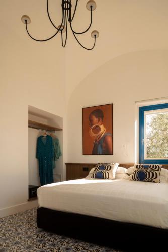 Ένα ή περισσότερα κρεβάτια σε δωμάτιο στο Relais Palazzo del Barone