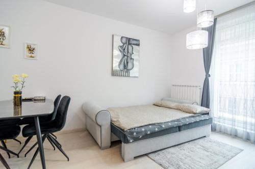 a small bedroom with a bed and a table at Paris luxury top centre Apt with office space in Sofia