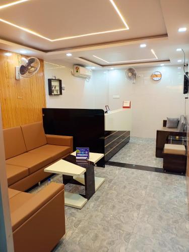 a waiting room with a couch and a table at Hotel Pink Paradise in Gorakhpur