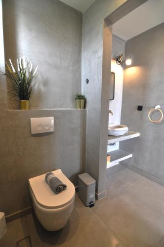 a bathroom with a toilet and a sink at Zennova #61, Boutique Studio in Nikiti in Nikiti