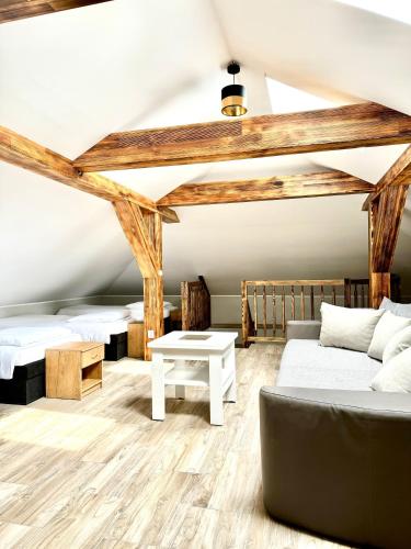 a room with two beds and a couch at Zielona Mila in Sępólno Krajeńskie