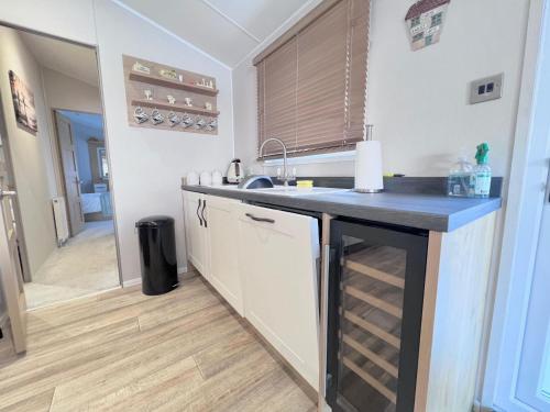 a kitchen with a sink and a counter top at Lakeside Dorchester Lodge - Hot Tub with Fishing Peg in Tattershall