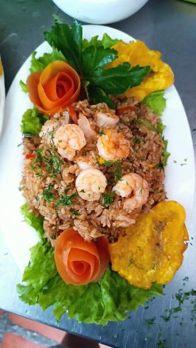 a plate of food with shrimp and rice at Manzanillo Beach in Cartagena de Indias