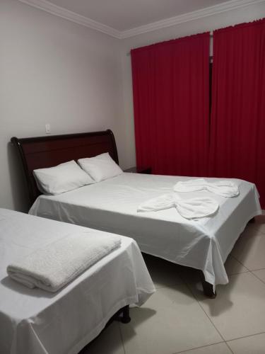 En eller flere senge i et værelse på Pousada residencial