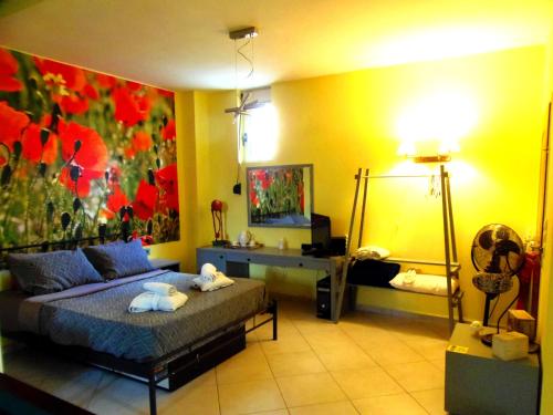 a bedroom with a bed and a painting on the wall at Vacation_Studio_near_the_beach in Heraklio