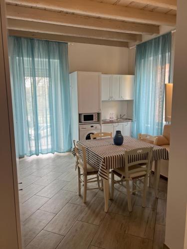 a kitchen and dining room with a table and chairs at I Colli del Garda in Lonato del Garda