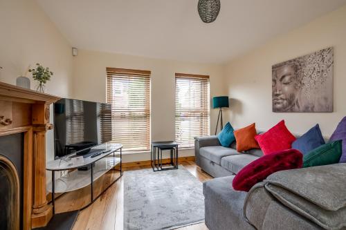 a living room with a couch and a tv at Stylish & spacious 3 bedroom entire house in Lisburn with parking in Lisburn