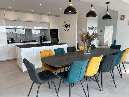 - une cuisine avec une table à manger et des chaises dans l'établissement Villa les dunes, à Carantec