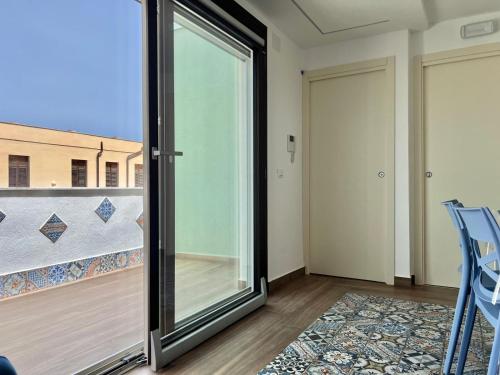 a glass door in a room with a balcony at M'AMA apartment 2 in Ficarazzi