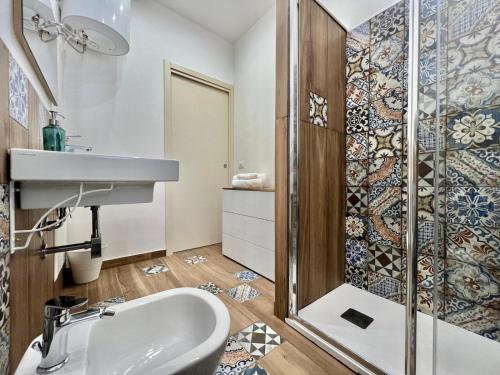 a bathroom with a sink and a shower at M'AMA apartment 2 in Ficarazzi
