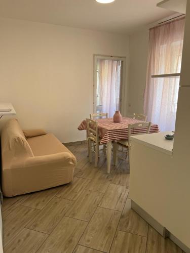 a living room with a table and a couch at I Colli del Garda in Lonato del Garda