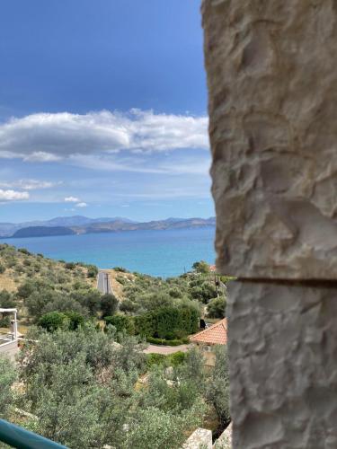 a view of the ocean from a stone wall at Anaval's View Apartments in Kivérion