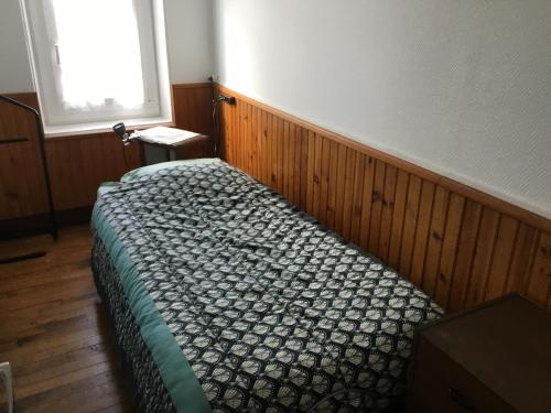a bedroom with a bed in a room with a window at Logement avec parking max 7 personnes in Eauze