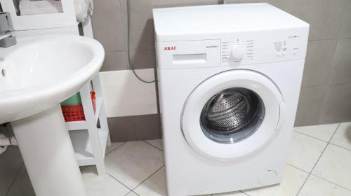 a white washing machine in a bathroom next to a sink at Il giardino di Mary in Pompei