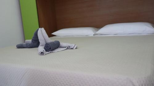 a stuffed animal is laying on a bed at Il giardino di Mary in Pompei