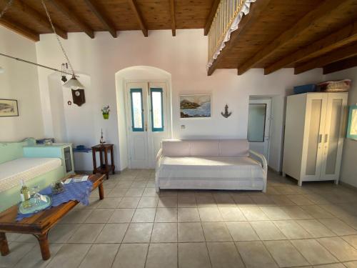 a living room with two beds and a table at Kleopatra Sweet Home in Symi