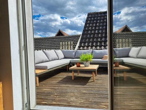 a balcony with couches and a table on a building at Art & Living Apartment in Schoneck