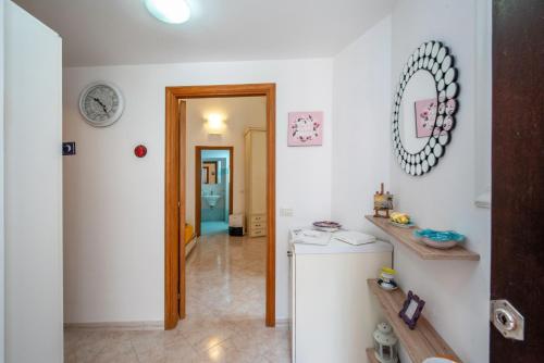 a kitchen with a refrigerator and a mirror on the wall at Casa Hermes in Atrani